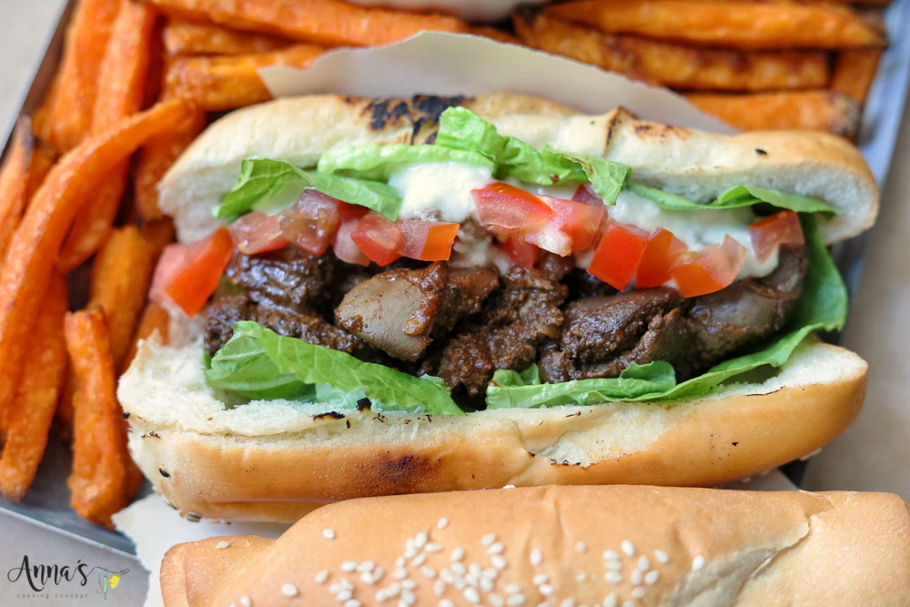 chicken livers serving suggestion: inside sesame sandwich bun with some Lebanese garlic paste, diced tomato and lettuce and some sweet potato airfried fries on the side