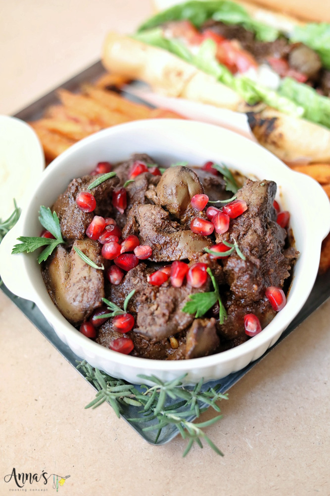 Lebanese chicken livers mezza garnished with pomegranate seeds and fresh rosemary and parsley leaves